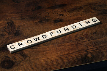 Crowdfunding word text on wooden background. Money Business Concept