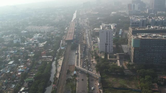 Sunrise aerial shot of highway in Chennai city filled with misty fog