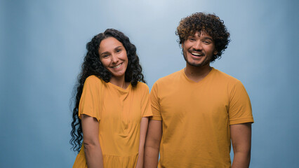 Blue studio background happy multiracial couple showing heart shape St Valentines Day romantic relationships love married man and woman sincere feelings followers kindness volunteering Ukraine support