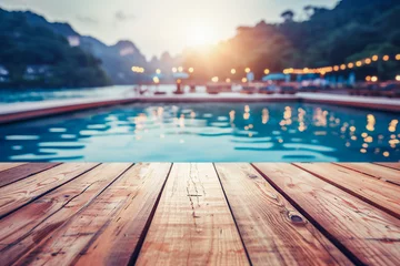 Poster Outdoor swimming pool background with empty wooden table © Ptitsyna