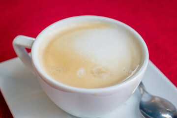 coffee in a white cup on a red background
