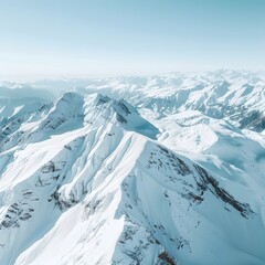 Aerial View of Snow-Capped Alpine Peaks Under a Clear Blue Sky: A Serene Winter Wonderland