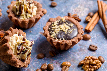 Chocolate baskets with nut cream. Homemade tartlets with cream and glaze