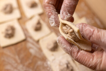 Pies are made from puff pastry and meat. Preparation of meat pies from puff pastry.
