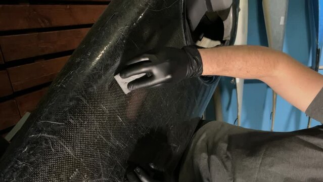 repair the boat. canoe repair. use resin .vertical video. slow motion video. High-quality 4K shooting