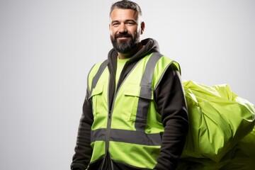 portrait of a smiling man wearing a green and gray vest