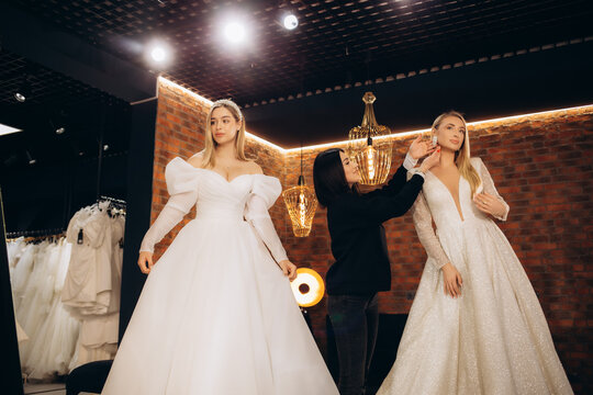 Two beautiful brides in a wedding salon