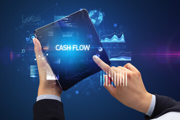 Businessman holding a foldable smartphone, business concept