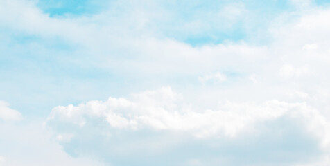 Blue sky with cumulus white fluffy cloud. Soft blur pastel sky for background backdrop. Beautiful...