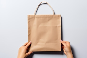 female hands hold craft paper bag mockup on a white background