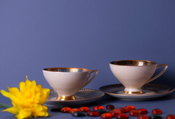 Close-up of old porcelain  white cups  and plates isolated on purple background