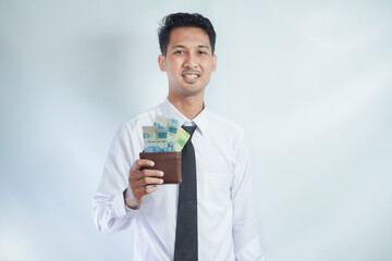 Adult Asian man smiling happy while showing his wallet full of paper money