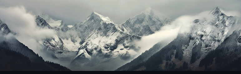 panorama landscape of mountains snowy peaks of rocks in fog and clouds.
