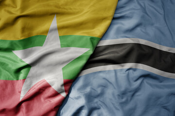 big waving national colorful flag of botswana and national flag of myanmar .
