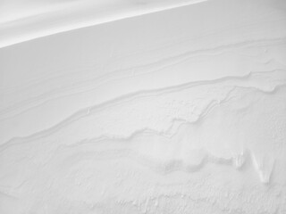 Snow texture. The wind in the tundra and in the mountains sculpts patterns and ridges on the snow...