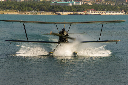 Seaplane Po-2. Multi-purpose Soviet biplane seaplane Polikarpov Po-2 or U-2 (NATO &ldquo;Mule&rdquo;) moves through water towards shore. Hydroaviation show - 2012. Gelendzhik, Russia - September 04, 2012