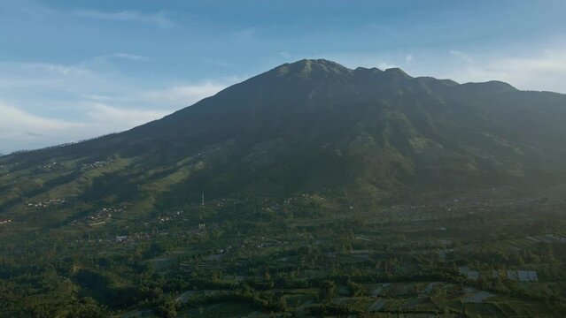 Breathtaking aerial view of Merbabu Mountain. Drone shot of tropical natural landscape in misty morning. Indonesia.