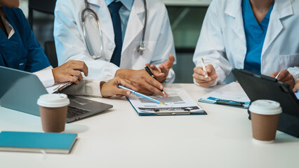 A diverse group of healthcare professionals, including doctors, nurses, and specialists, engaging in a collaborative meeting to discuss medical cases and share expertise in a hospital