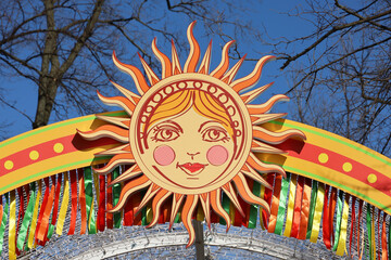 Smiling sun, Shrovetide decorations on a street. Traditional spring festival Pancake week