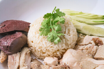 Hainanese chicken rice with soup on dark wooden table background. thaifood concept.