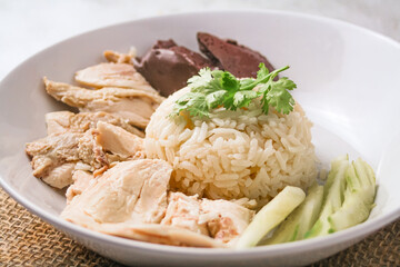 Hainanese chicken rice with soup on dark wooden table background. thaifood concept.