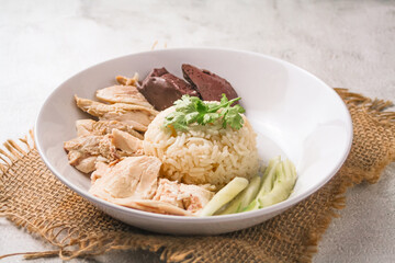 Hainanese chicken rice with soup on dark wooden table background. thaifood concept.