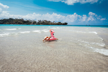 Travel to the sea and islands Woman walking into the clear sea on the island