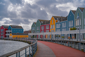 Colourful wooden lakeside houses De Rietplas. Modern residential architecture in Houten, The...