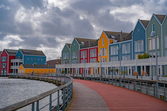 Colourful wooden lakeside houses De Rietplas. Modern residential architecture in Houten, The Netherlands