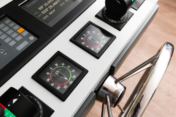 Azimuth thrusters angle indicators mounted in a tug boat control panel