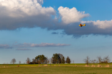 A spray plane applies chemicals to a field. Agricultural aviation.