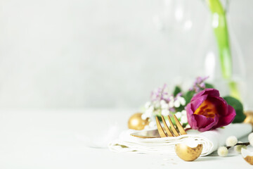 Easter table decorations on light grey background copy space