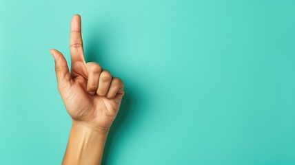 Hand pointing upwards against a turquoise background