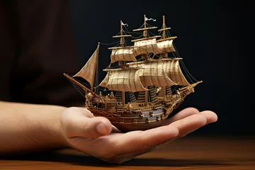 Schilderijen op glas Model of old ship in hands on dark background. 3d rendering. pirate ship mini model. miniature sailboat. © Jahan Mirovi