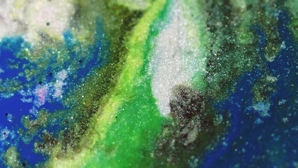 Glitter paint spill. Ink flow. Blur green blue pink white color shimmering grain texture liquid mix...