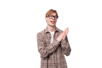 young caucasian man with red hair wears glasses and a shirt