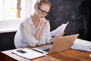 Reading, glasses and woman with report in office and review of professional research, portfolio and business. Check, paperwork and learning from information or analysis of knowledge in folder at desk