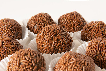 Brigadeiro brazilian chocolate truffle balls candy and chocolate flakes front view clean background