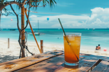 A drink on a table beside a beach