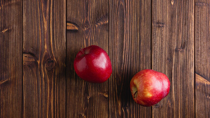Red apples on a wooden background