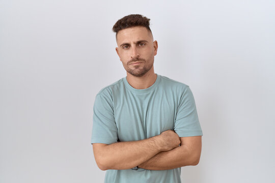 Hispanic man with beard standing over white background skeptic and nervous, frowning upset because of problem. negative person.