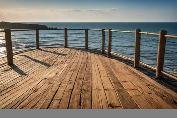 Tuinposter wooden pier in the sea © eman