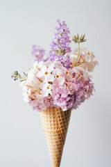 Ice cream cone with flowers on white background. 