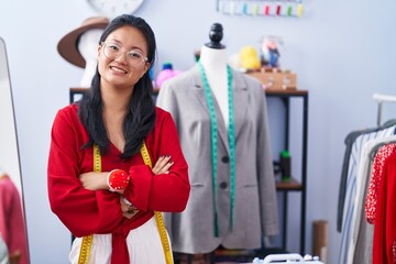 Young chinese woman tailor smiling confident standing with arms crossed gesture at atelier