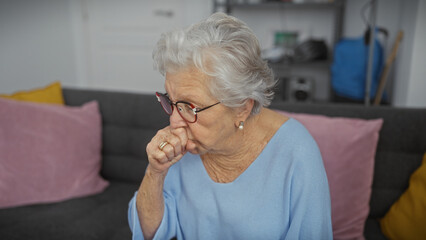 Elderly woman coughing indoors, showcasing health, senior lifestyle, and care within a domestic environment.