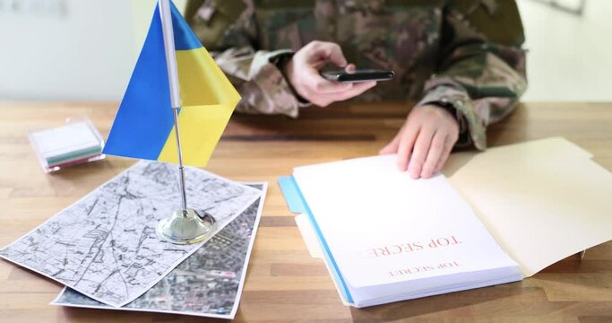 Military spy photographing top secret document on planning of counteroffensive by ukrainian troops into russia closeup 4k movie slow motion. Intelligence and information leakage during war in ukraine