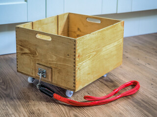 upcycled wooden wine crate box to create a utility trolley with red chord pull handle