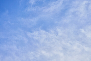 A tranquil sky with fluffy white clouds scattered across the expansive blue atmosphere, perfect for backgrounds.