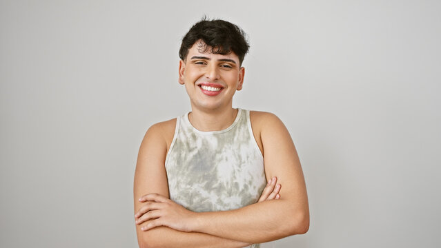 Smiling young man with crossed arms wearing tank top against plain white background