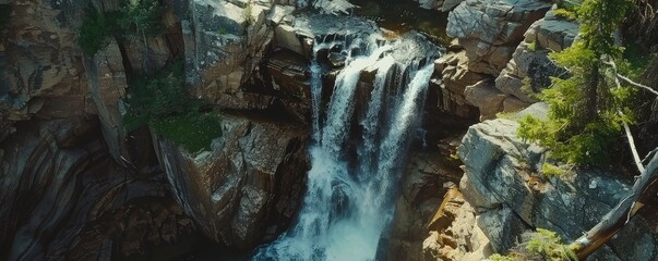 Fototapeta premium Aerial view of a breathtaking waterfall in rock cliff
